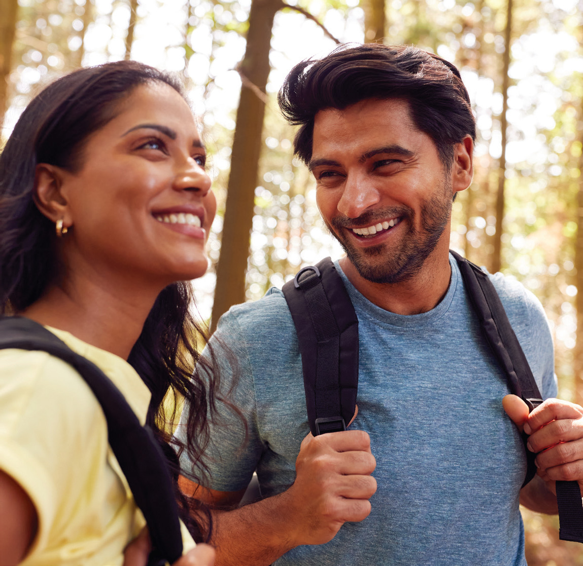 Young Couple standing smiling while hiking in Milton's Trails near YT on Fourth Milton townhomes and single detached homes